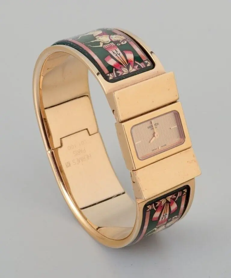 Hermès Damenarmbanduhr aus vergoldetem Metall mit emaillierten Details